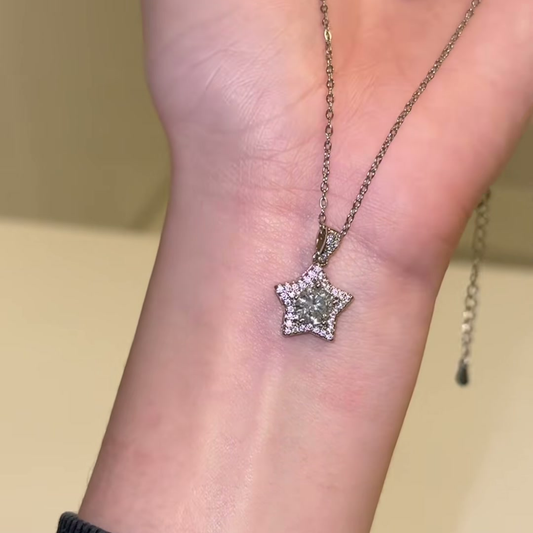 Source-video forearm view showing the star pendant, detailed bail and chain