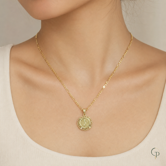 Gold-color round medallion necklace worn at the collarbone with a neutral top