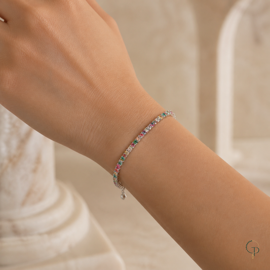 Single multicolor tennis bracelet fastened around a wrist