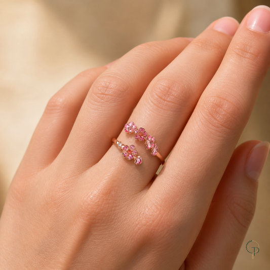 Pink blossom open bypass ring worn correctly around a finger