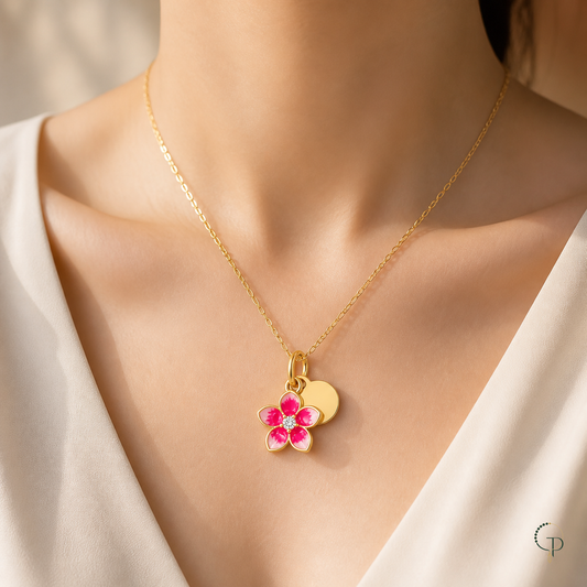 Gold-color pink blossom pendant necklace worn at the collarbone with an ivory blouse