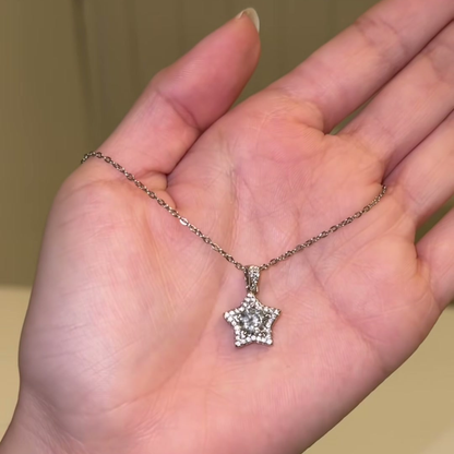 Source-video hand view showing the star pendant necklace for visual scale