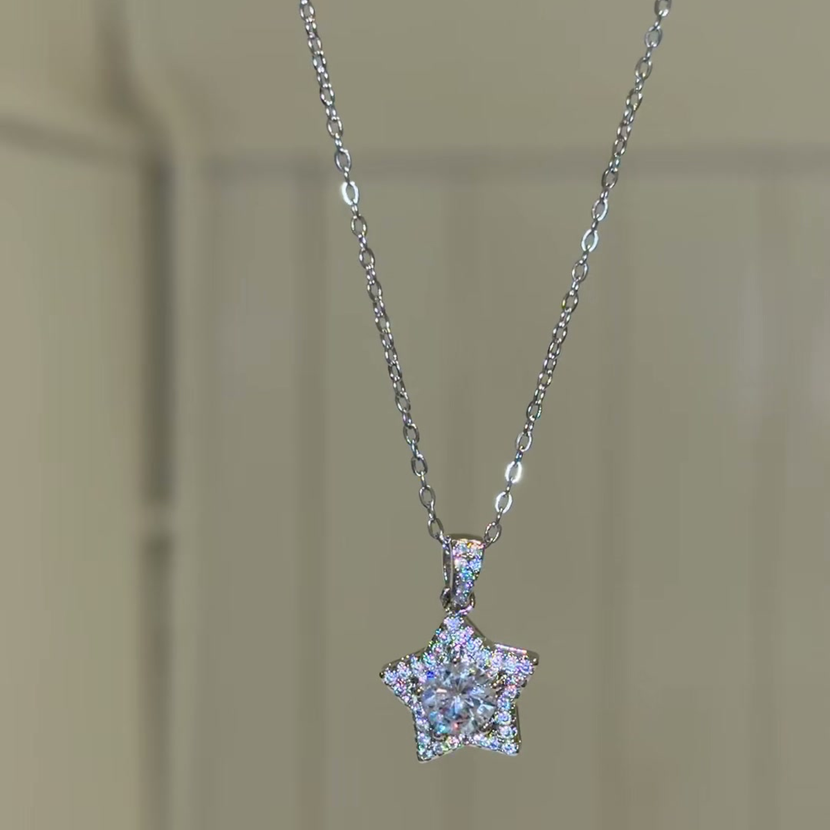 Source-video front view of the silver-color star pendant and fine chain