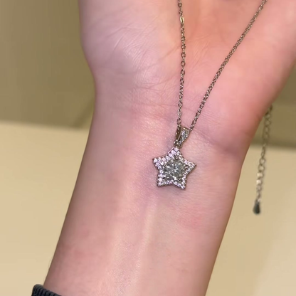 Source-video forearm view showing the star pendant, detailed bail and chain