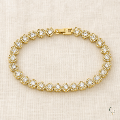 Complete gold-color heart-link bracelet arranged on ivory linen