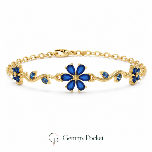 Cobalt blue six-petal flower vine bracelet on a seamless white studio background