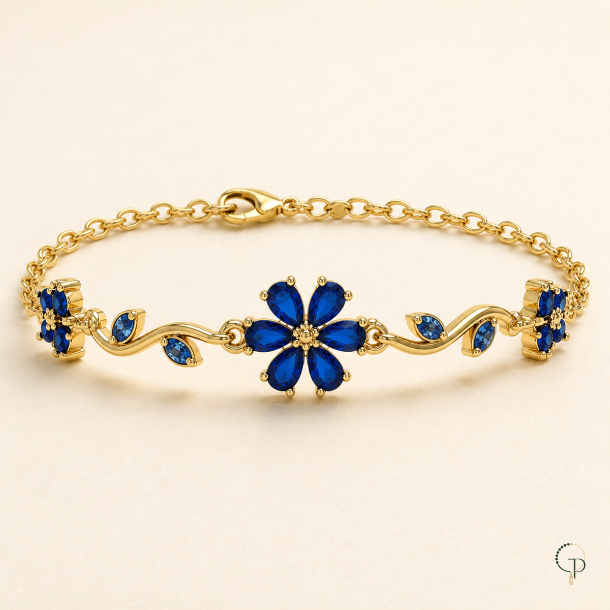 Close studio view of the blue flower and leaf-shaped details on the vine bracelet