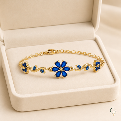 Cobalt blue floral vine bracelet displayed in an unbranded ivory jewelry box