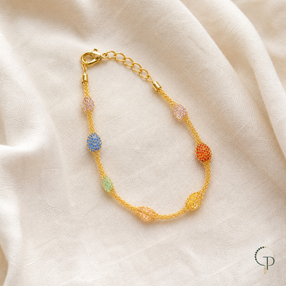 Rainbow mesh bead bracelet with seven colorful stations on ivory linen | PureNoi
