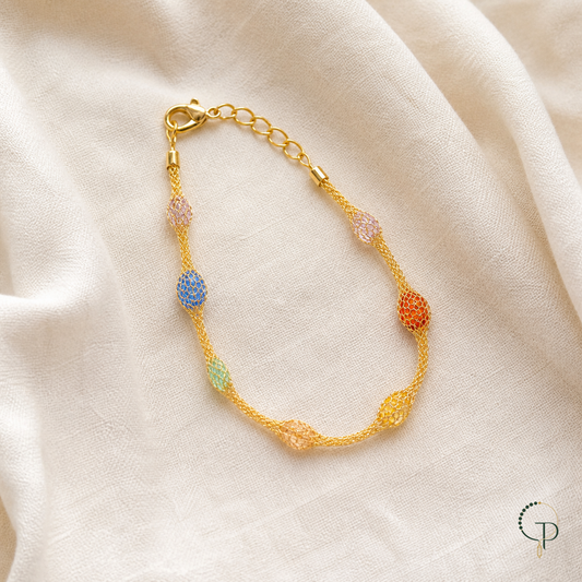 Rainbow mesh bead bracelet with seven colorful stations on ivory linen | PureNoi