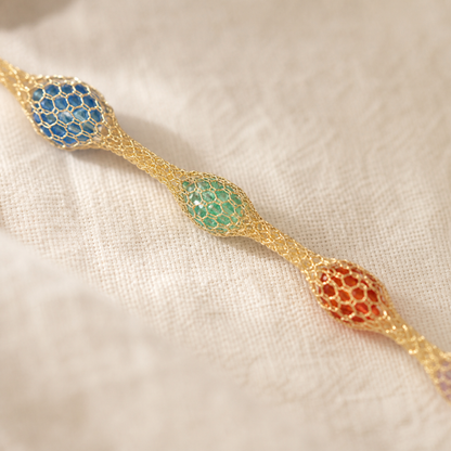 Close-up of colorful bead-filled mesh stations on rainbow bracelet