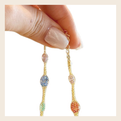 Close-up of lobster clasp and extension chain on rainbow mesh bracelet