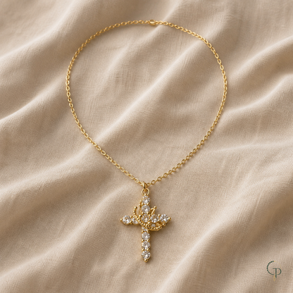 Gold-color crown cross pendant necklace on warm oatmeal linen