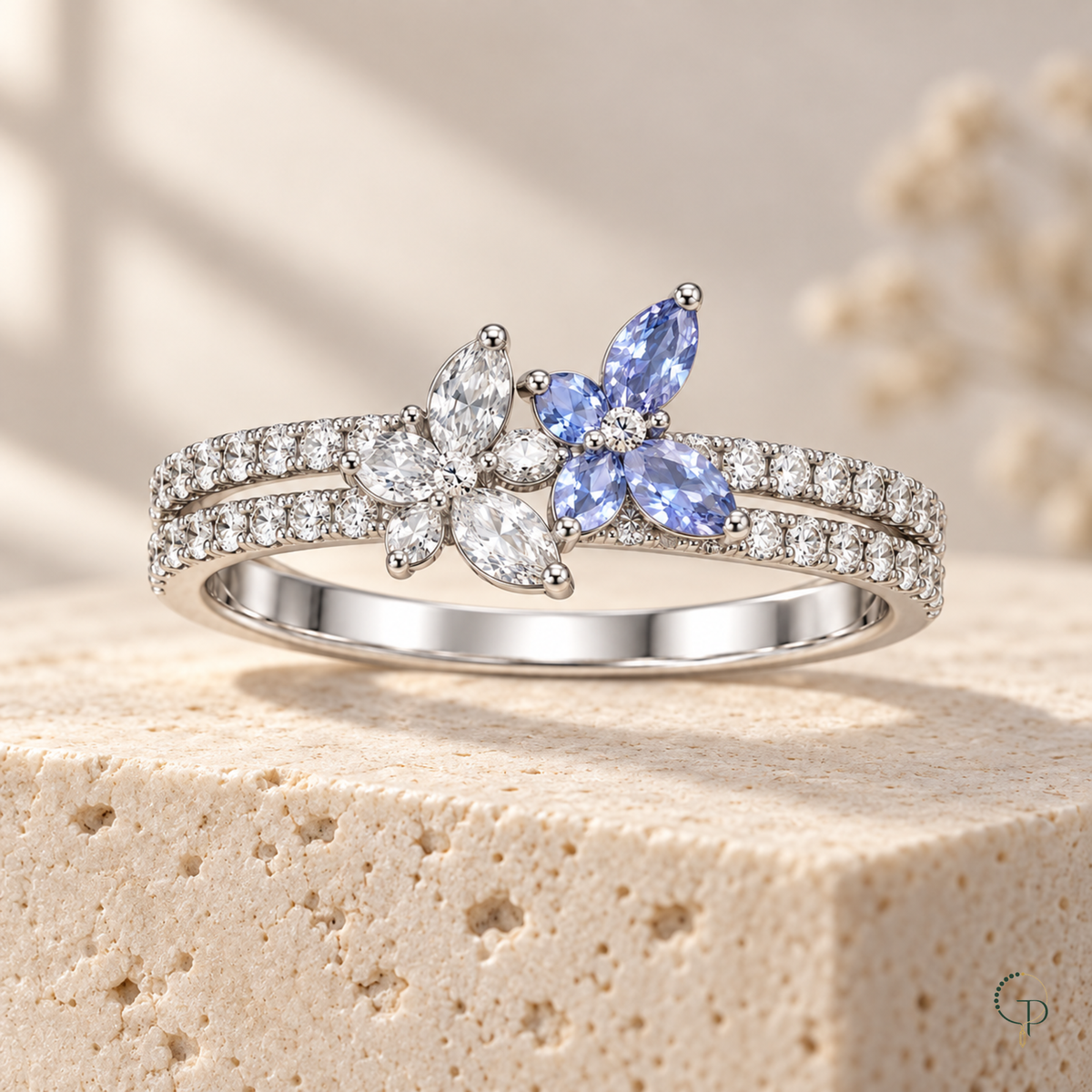 Clear and pale blue butterfly ring styled on a neutral stone surface