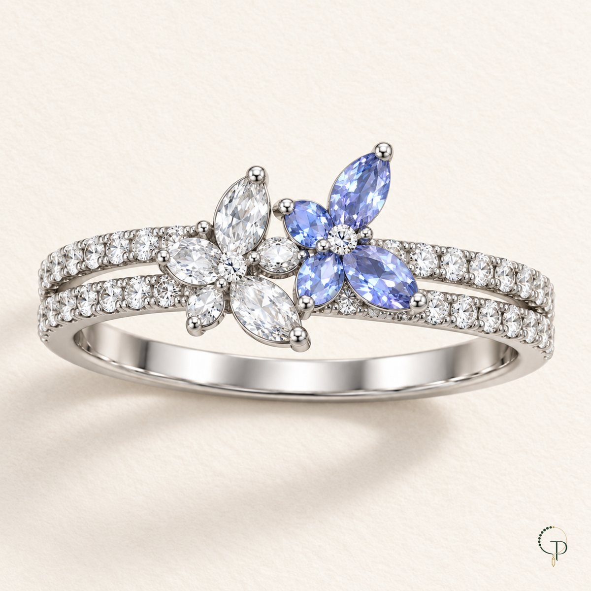 Silver-tone double butterfly ring arranged on softly folded ivory fabric