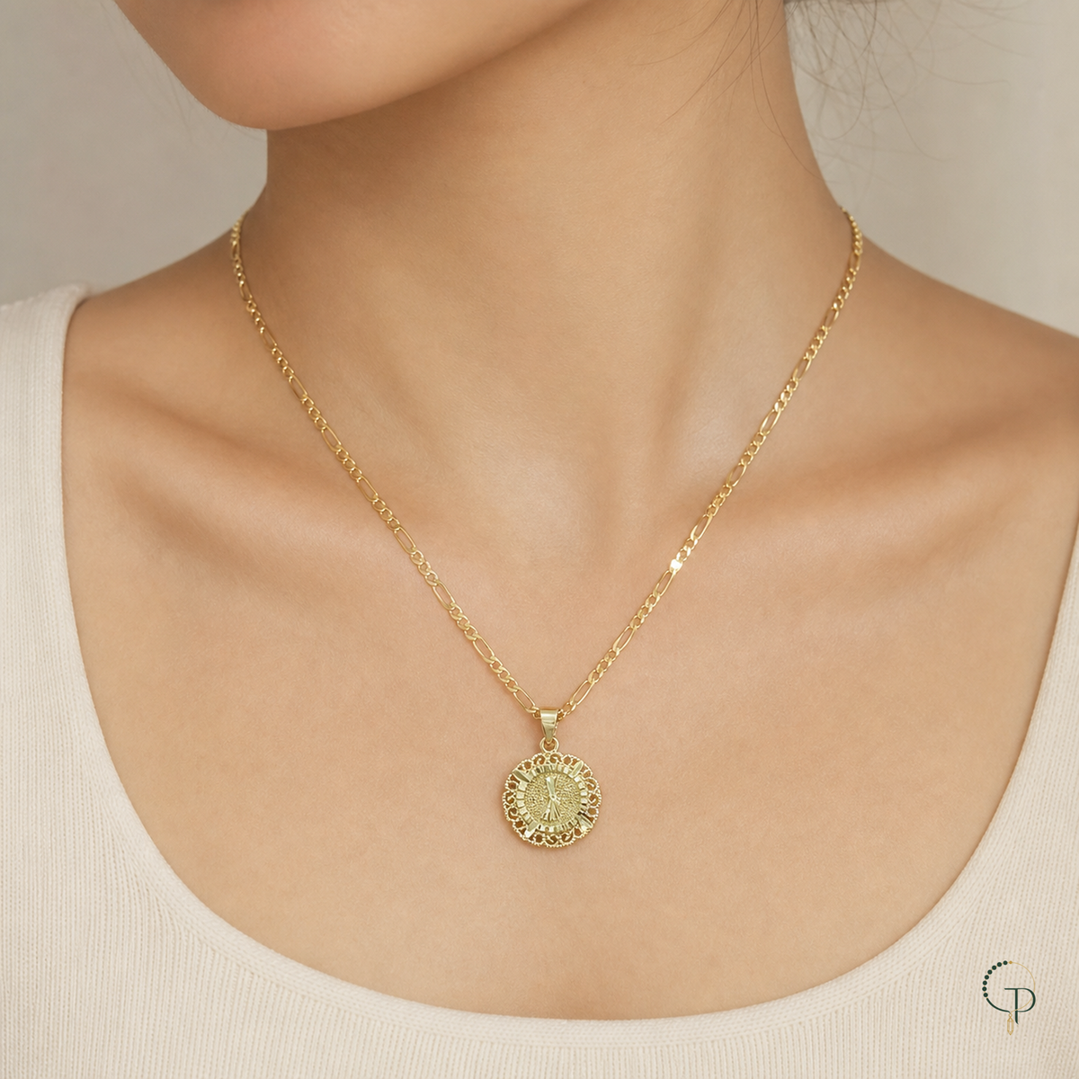 Gold-color round medallion necklace worn at the collarbone with a neutral top