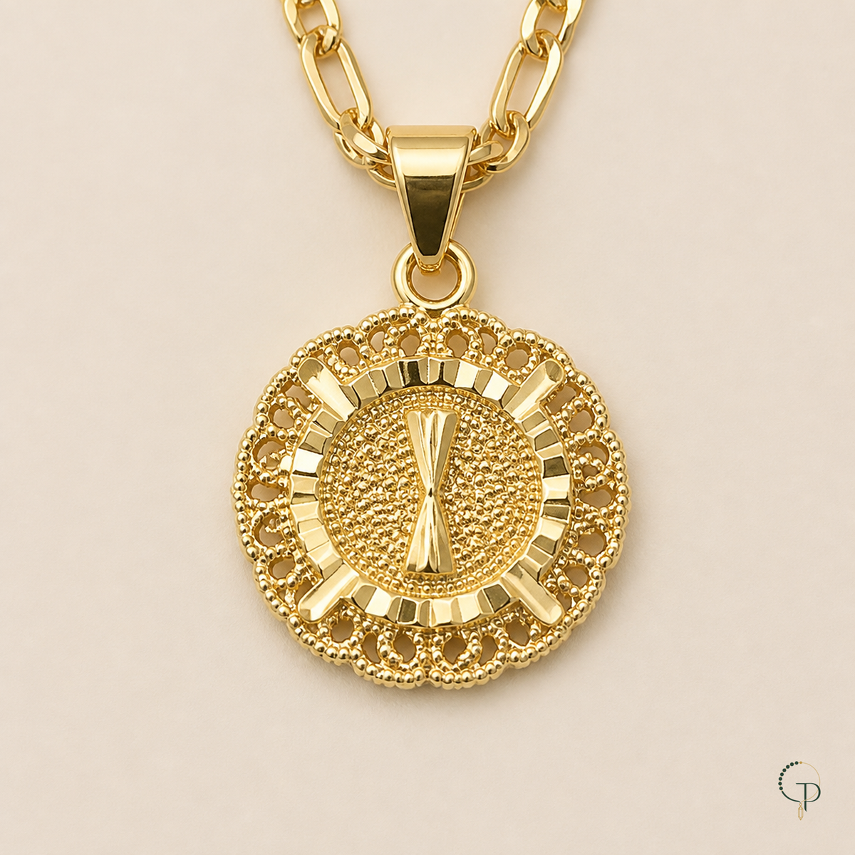Close front view of the filigree halo, textured center and polished pendant bail