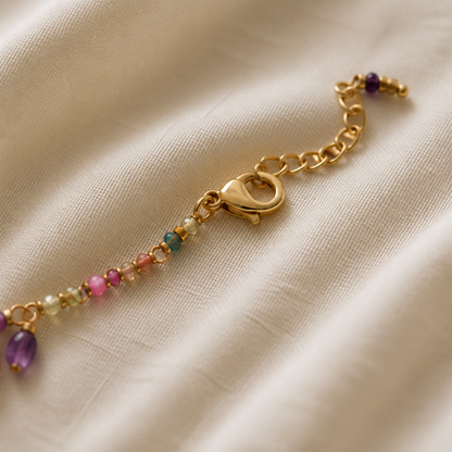Close-up of lobster clasp and extension chain on beaded charm necklace