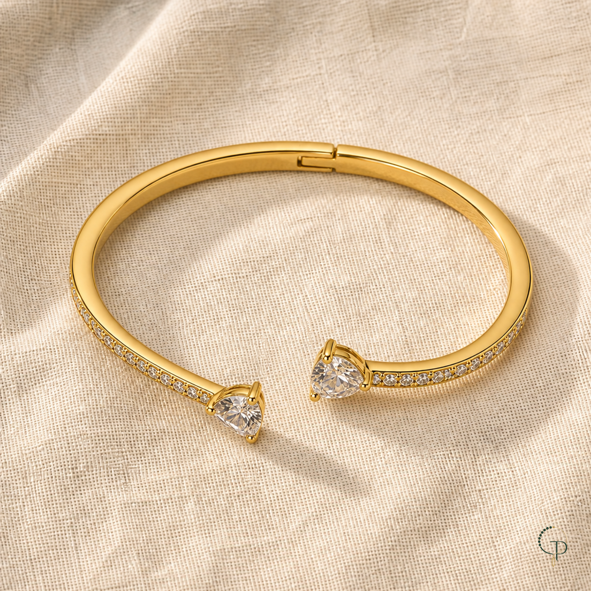 Complete asymmetric double-heart bangle with rear hinge on ivory linen