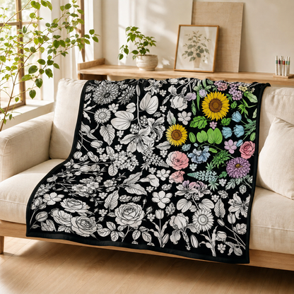 Botanical coloring blanket draped over an ivory sofa