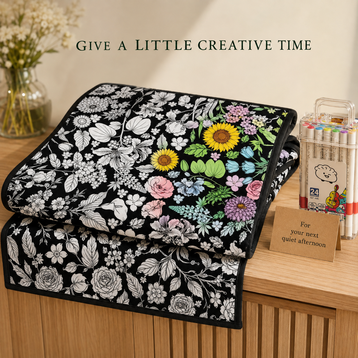 Botanical coloring blanket and markers in a styled gifting scene; card and props not included