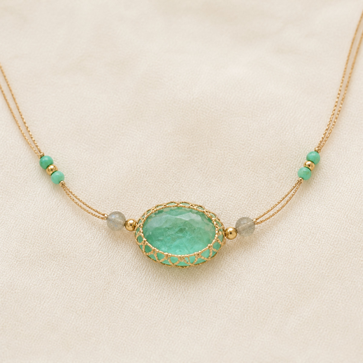 Full double-cord aqua stone bracelet laid flat on ivory linen