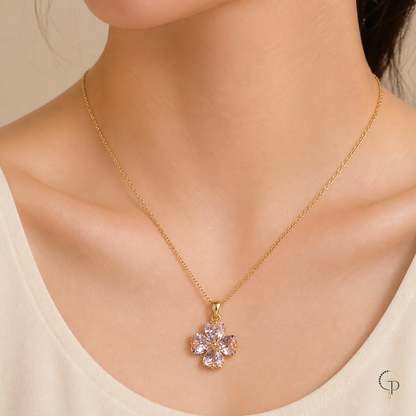 Clear blush four-leaf clover pendant necklace worn with a cream neckline