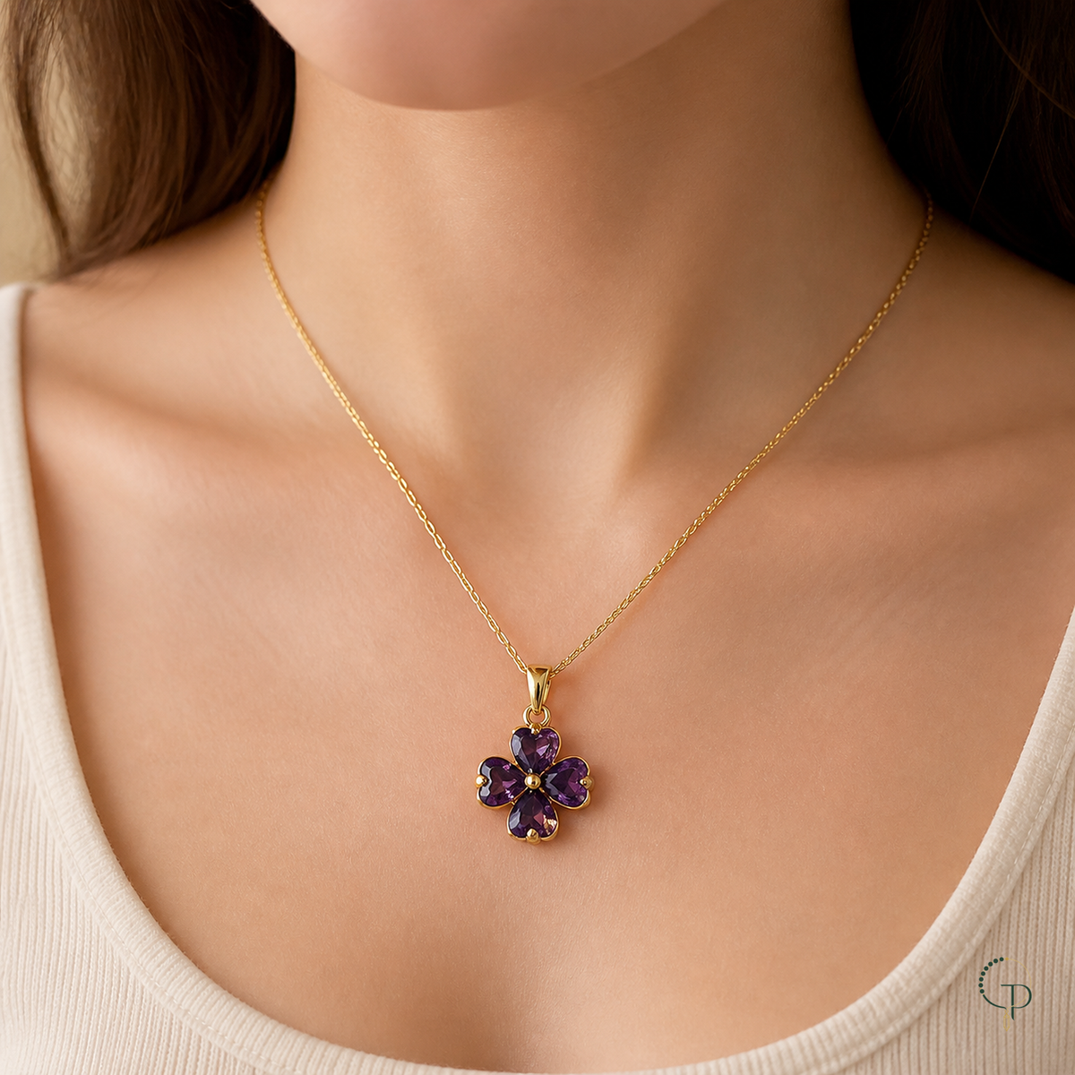 Purple four-leaf clover pendant necklace worn with a cream neckline