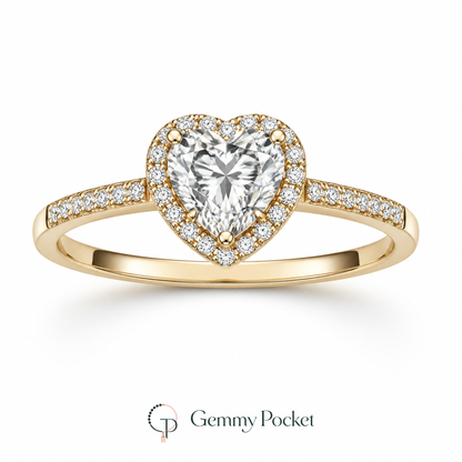 Gold-color heart halo ring with clear center stone on a white studio background