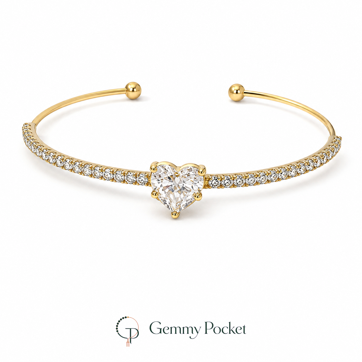 Gold-color open cuff bracelet with a clear heart-shaped center stone on a white background.