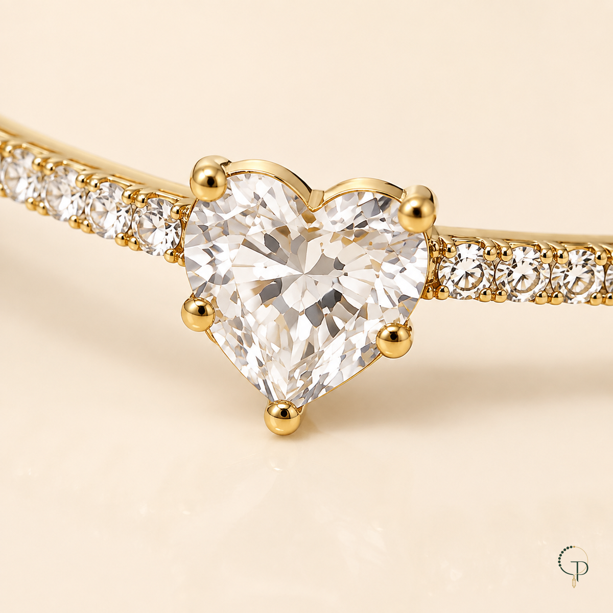 Close-up of the clear faceted heart stone, gold-color prongs and stone-set front band.