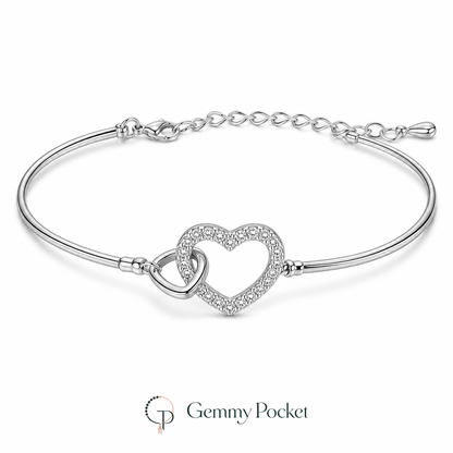 Silver-color interlocking double-heart bracelet on a seamless white studio background