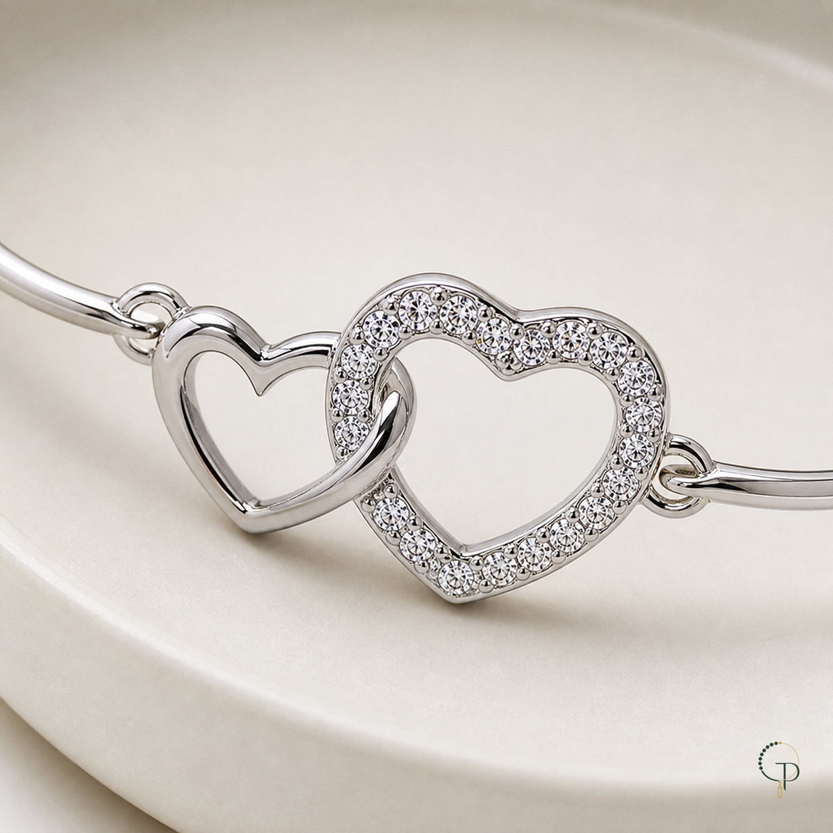 Close view of the smooth and stone-bordered interlocking heart motifs