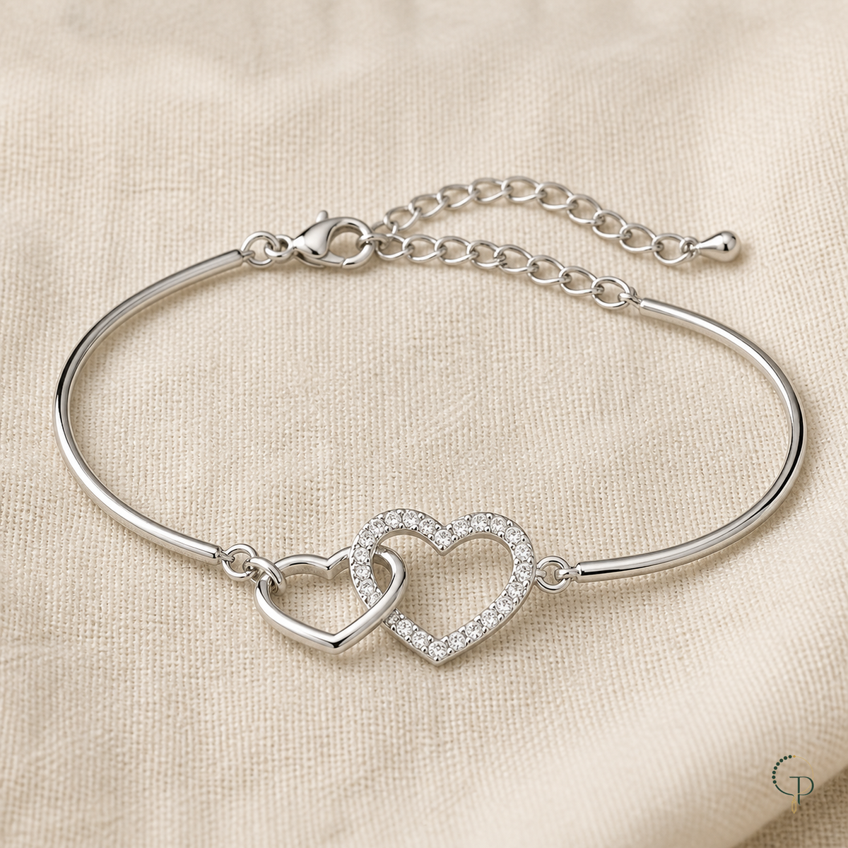 Complete silver-color double-heart bracelet and extension chain on ivory linen