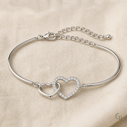 Complete silver-color double-heart bracelet and extension chain on ivory linen