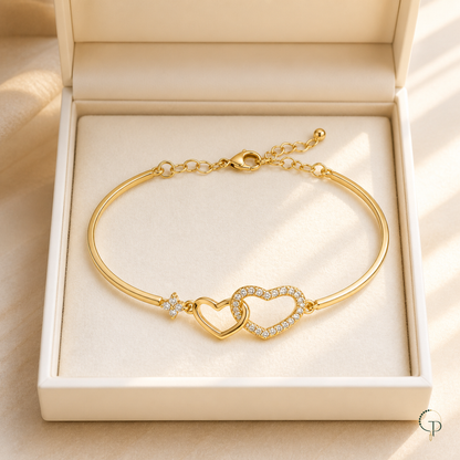 Interlocking heart bracelet displayed in an unbranded ivory jewelry box