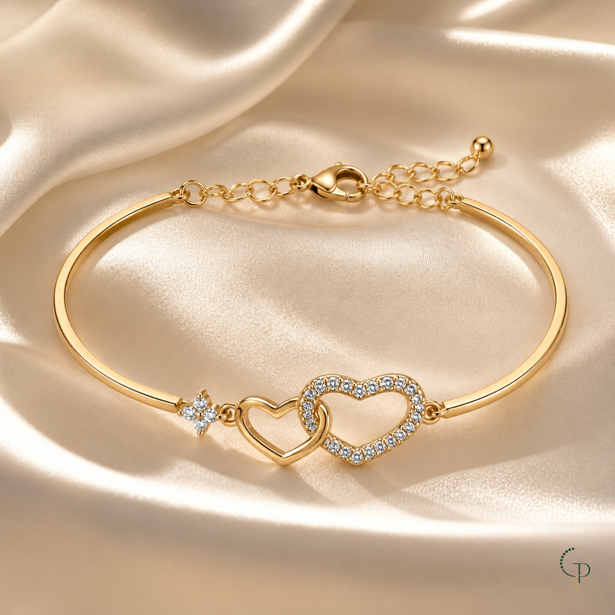 Gold-color interlocking heart bracelet styled on cream satin