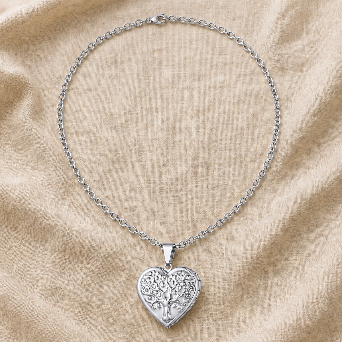 Silver tree of life heart locket necklace on warm ivory linen