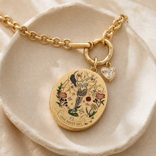 Three-quarter view of botanical skeleton medallion, heart charm and circular clasp