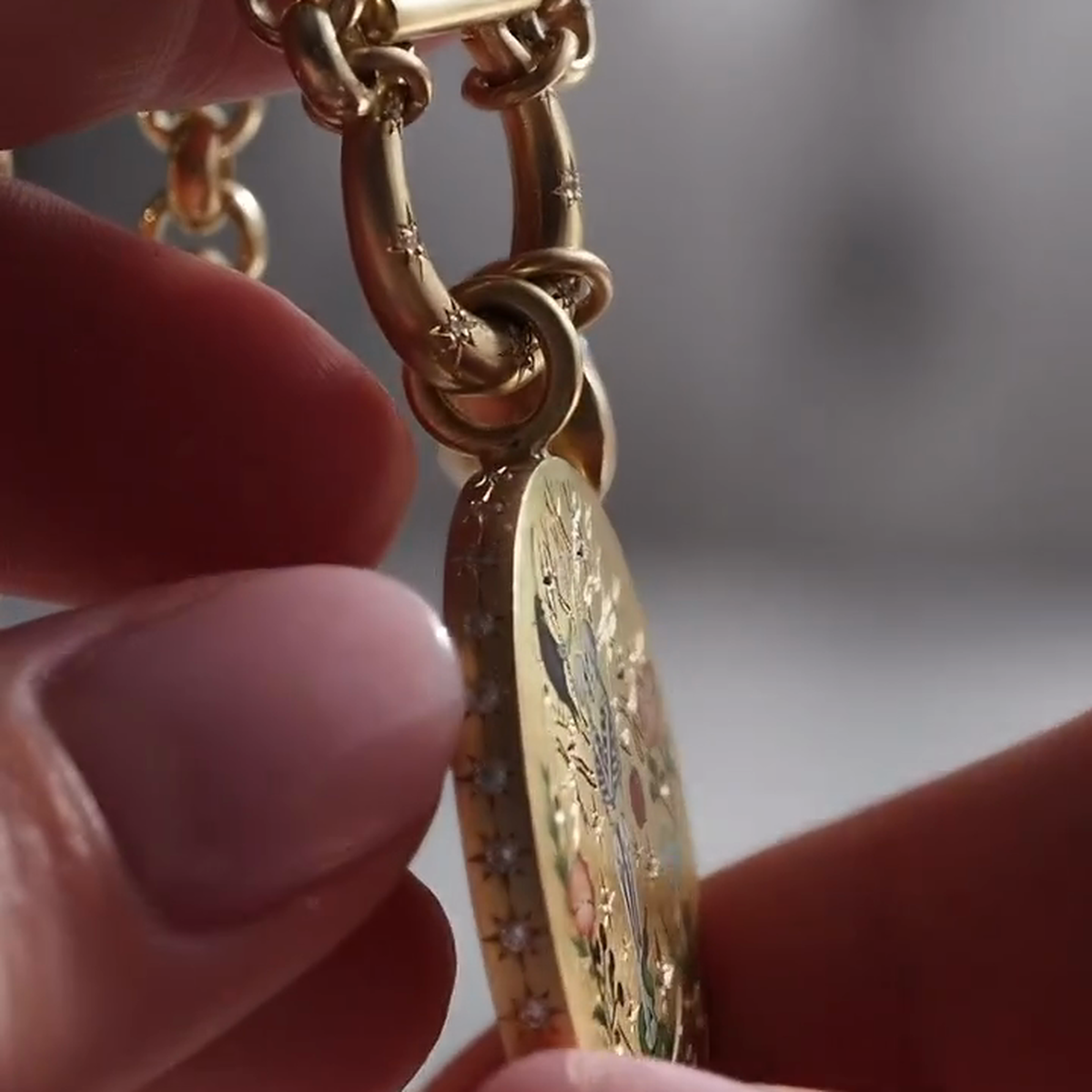 Side profile showing the oval medallion edge, small stones and pendant connector