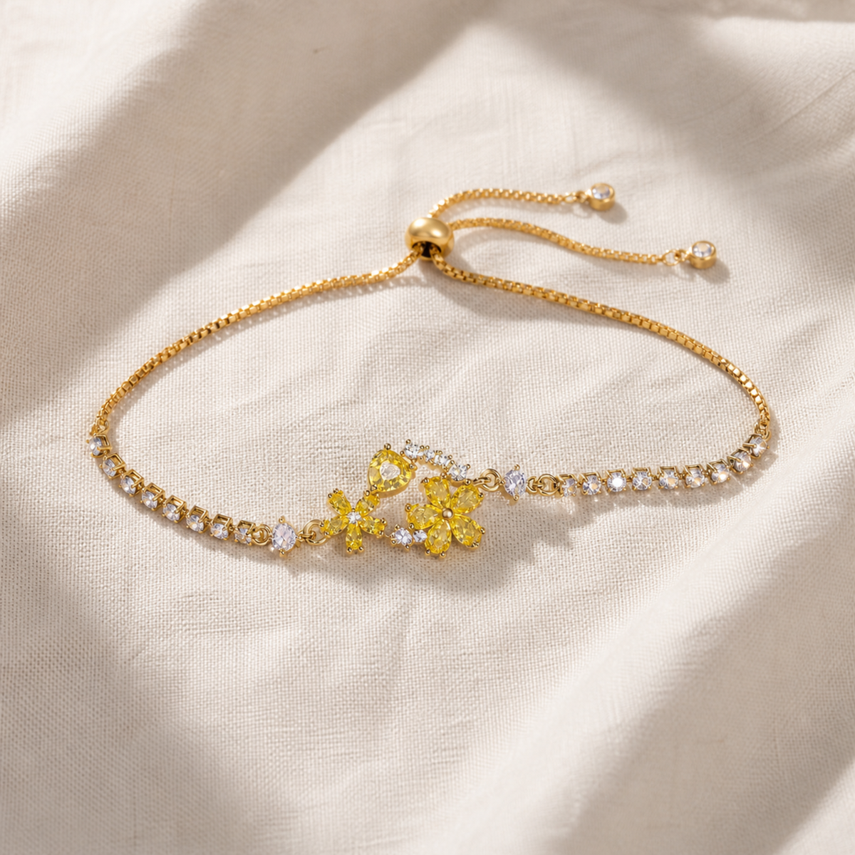 Yellow floral crystal tennis bracelet with gold-color adjustable slider chain