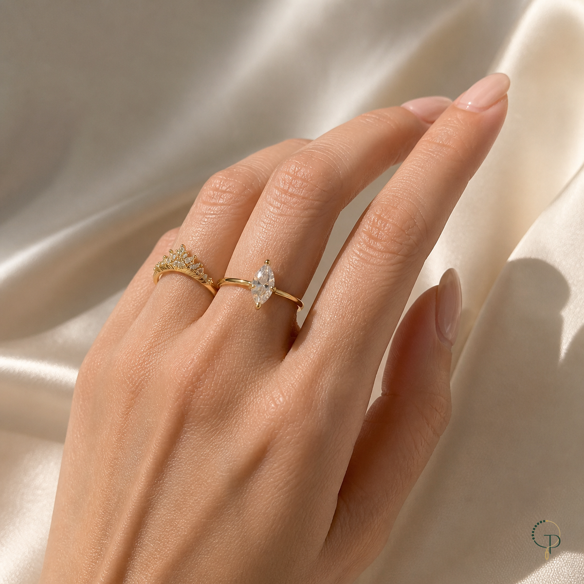 Marquise solitaire, crown ring and curved accent ring worn separately on an anonymous hand