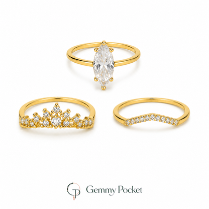 Three-piece gold-color marquise crown stacking ring set on a white studio background