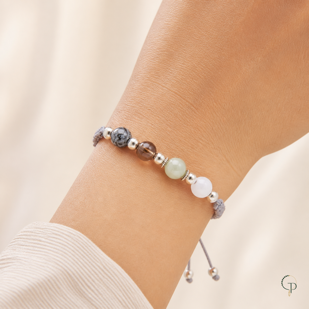 Mixed-bead gray braided cord bracelet worn naturally around the wrist