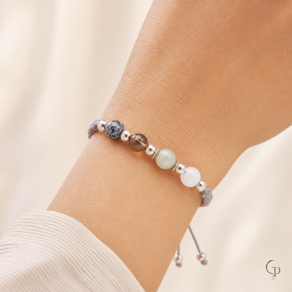 Mixed-bead gray braided cord bracelet worn naturally around the wrist