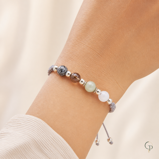 Mixed-bead gray braided cord bracelet worn naturally around the wrist