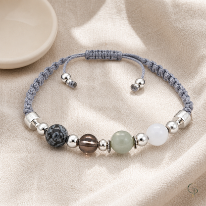 Full adjustable gray braided cord bracelet arranged on oatmeal linen