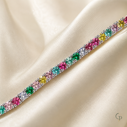 Macro detail of pink, aqua, green, yellow and clear round stones in one row