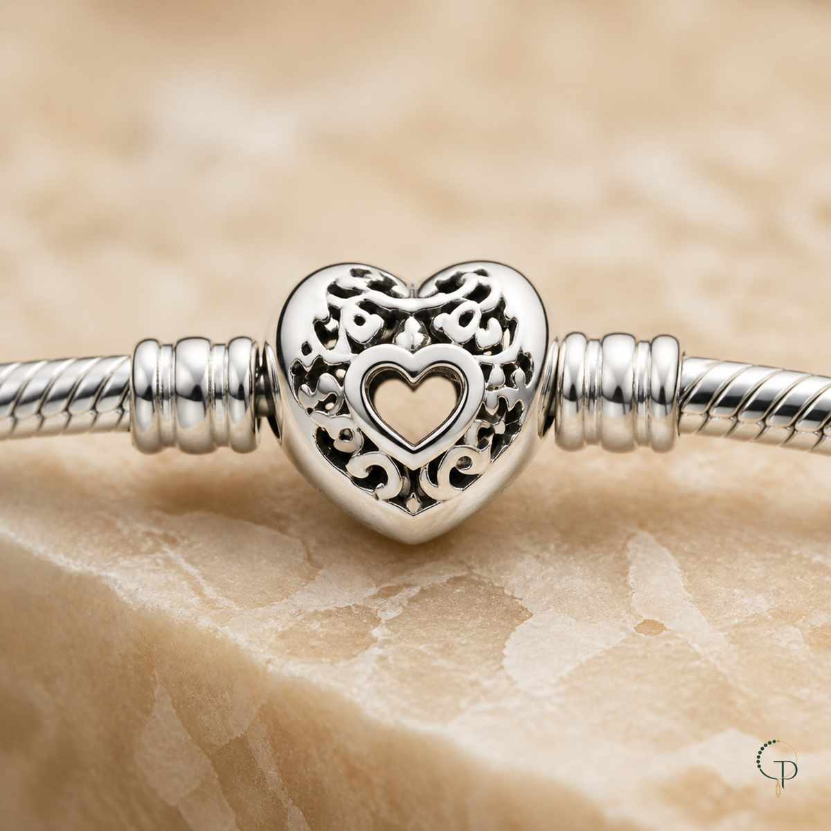 Macro view of the floral-scroll openwork heart clasp and stopper collars