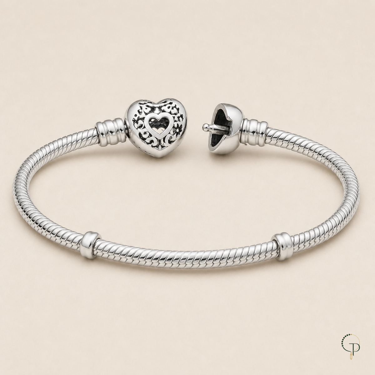 Open heart clasp construction and bare snake-chain bracelet detail